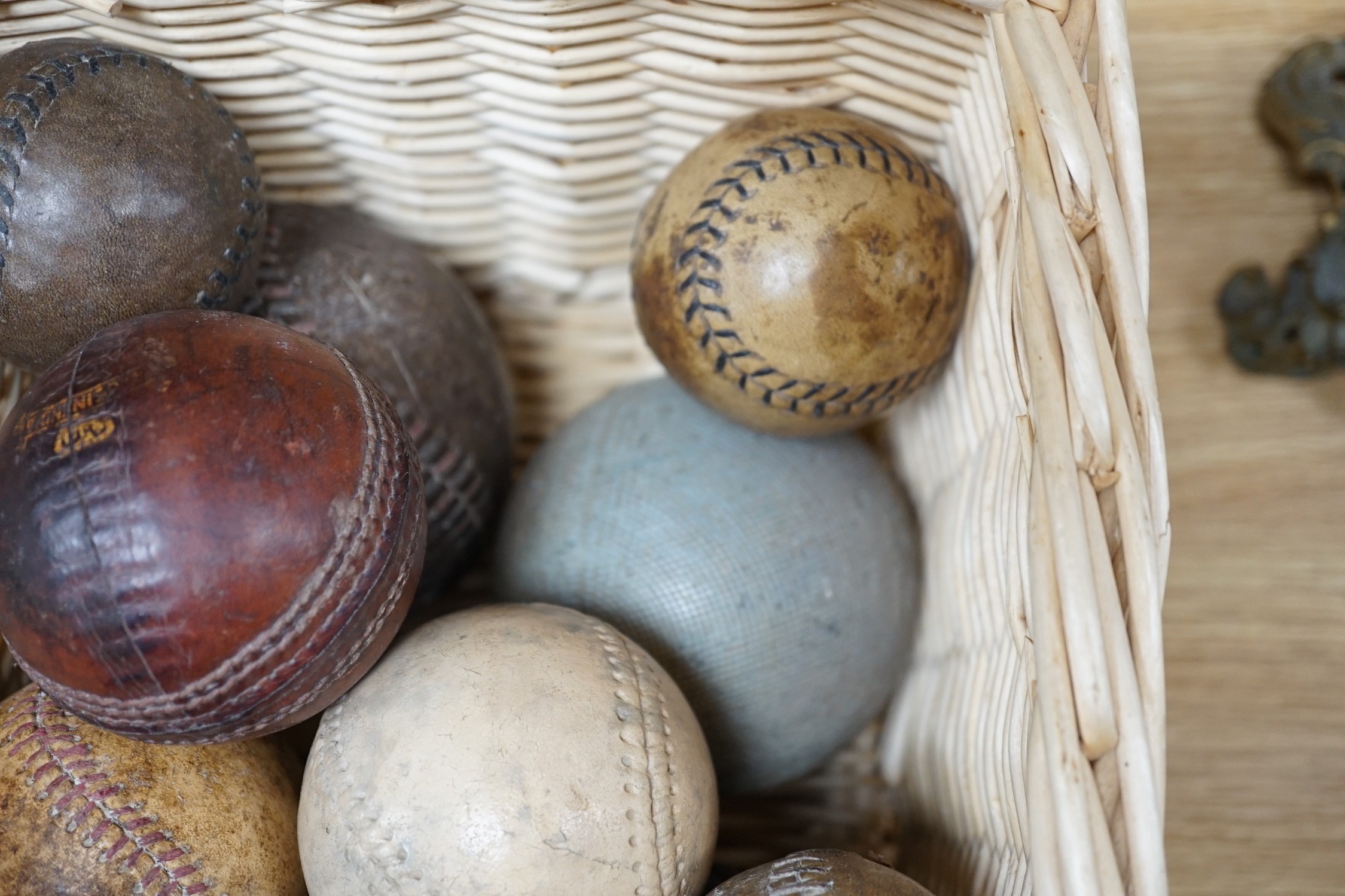 A collection of leather cricket and sporting balls